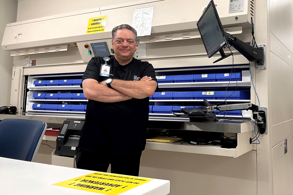 Gene B. Decaminada with his arms crossed in his lab.